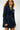 Upcycled denim blazer-style dress with minimal cut and bold zip accents.