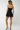 navy mini skort with structured panels and asymmetric pleats